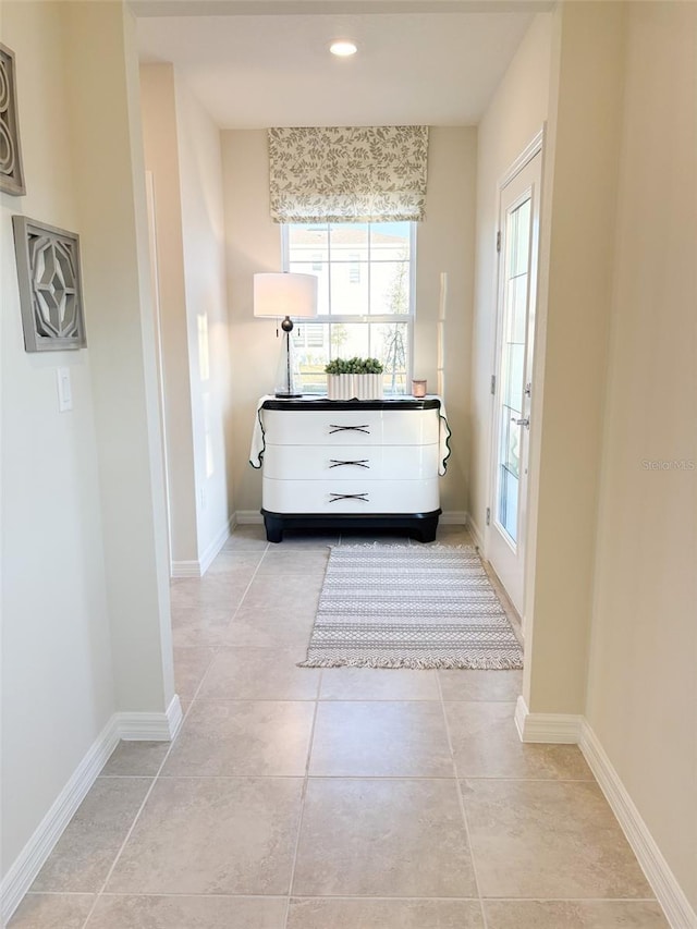 corridor featuring light tile patterned floors