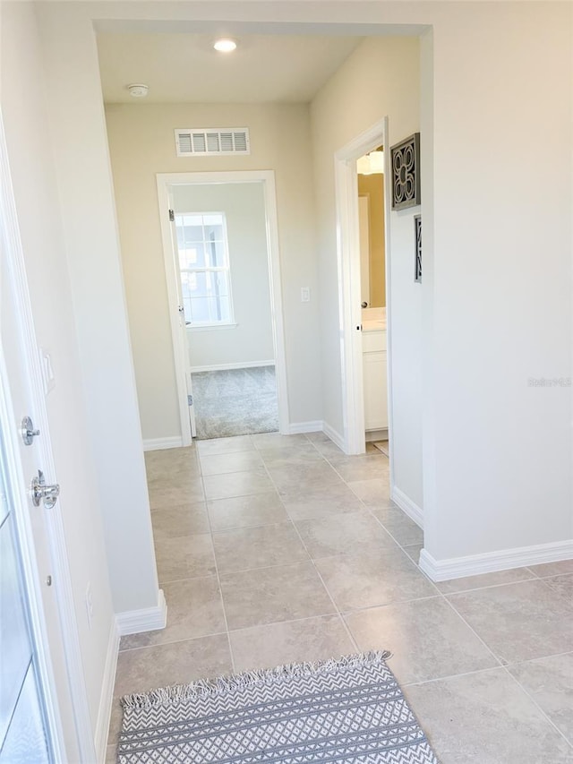 corridor with light tile patterned flooring