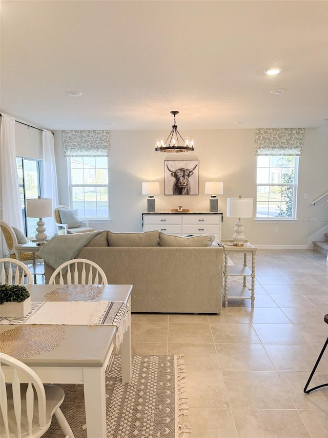 living room with light tile patterned flooring and an inviting chandelier