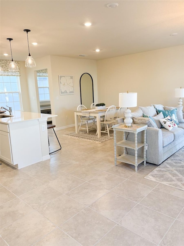 living room featuring light tile patterned floors and sink