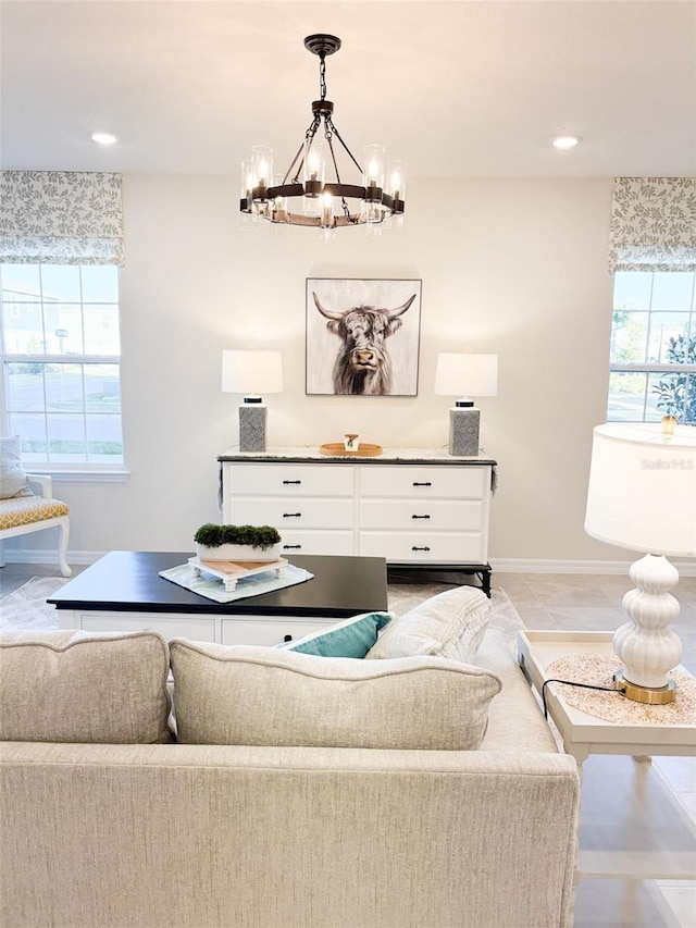 tiled living room featuring a chandelier and a healthy amount of sunlight