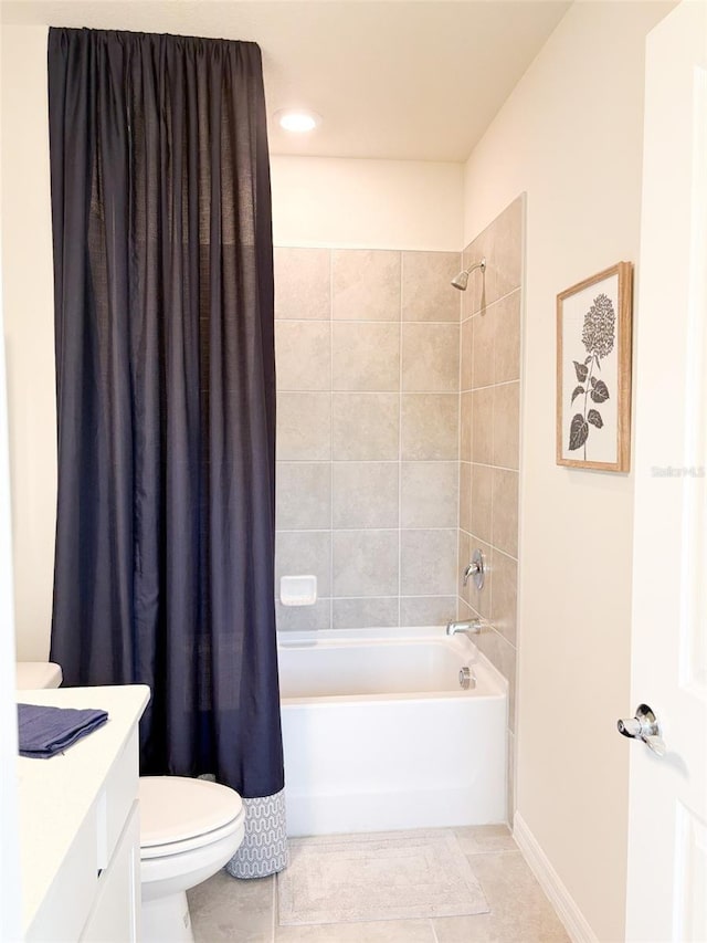 full bathroom featuring shower / bath combo with shower curtain, tile patterned floors, toilet, and vanity