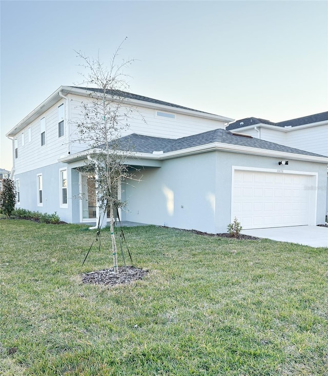 view of front facade with a garage and a front lawn