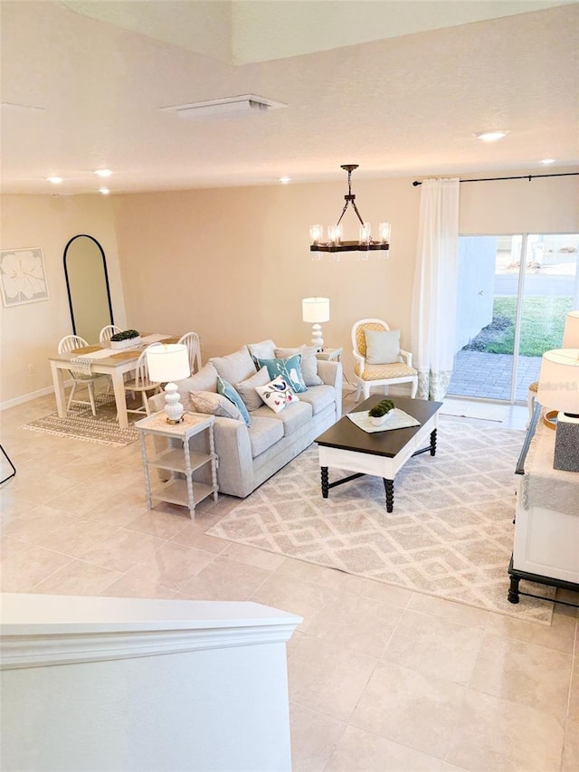 living room with light tile patterned flooring and an inviting chandelier