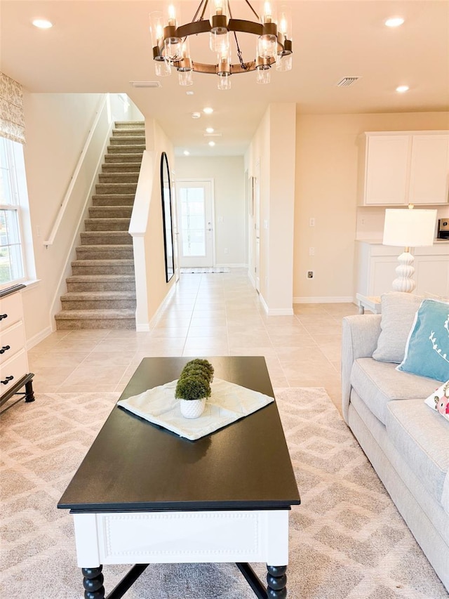 tiled living room with an inviting chandelier