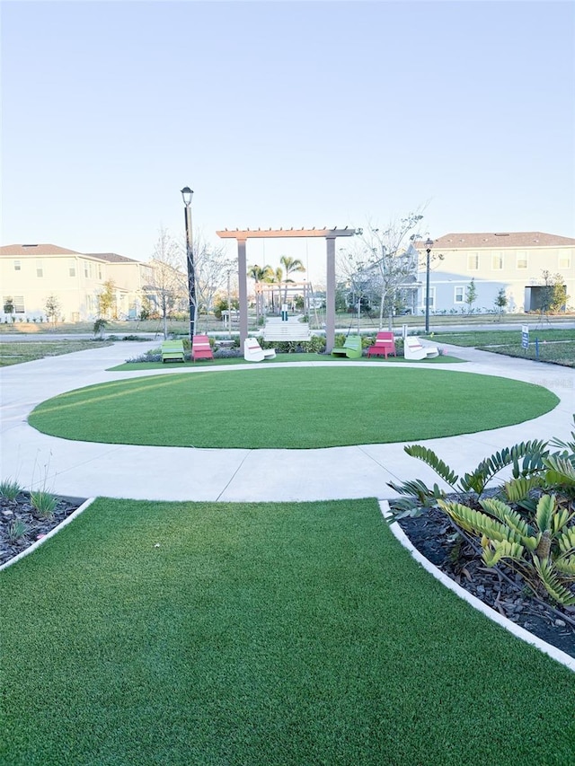 view of home's community featuring a lawn