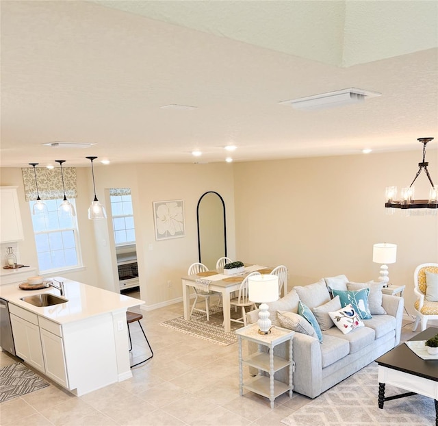 tiled living room with a notable chandelier and sink