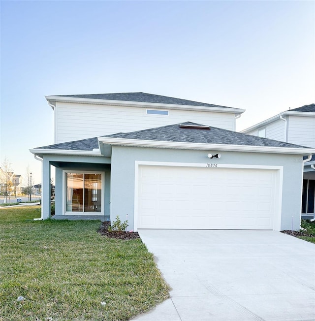 view of front of house featuring a garage and a front yard