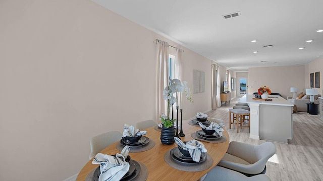 dining space with light hardwood / wood-style floors