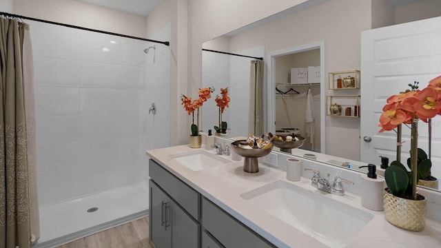 bathroom with hardwood / wood-style floors, vanity, and curtained shower