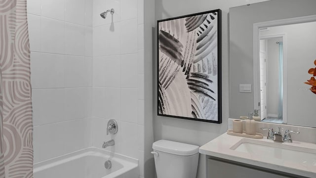 full bathroom featuring toilet, tiled shower / bath combo, and vanity