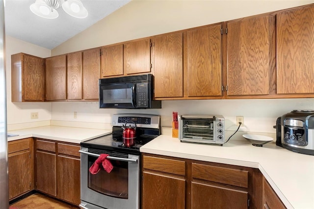 kitchen featuring electric range and vaulted ceiling