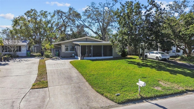 ranch-style house with a front lawn and a sunroom