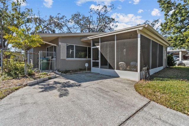 view of front of house featuring a sunroom