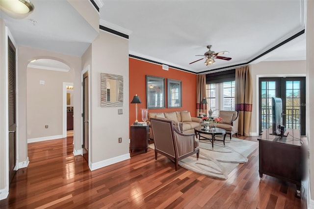 living room featuring french doors, ceiling fan, crown molding, and dark hardwood / wood-style floors