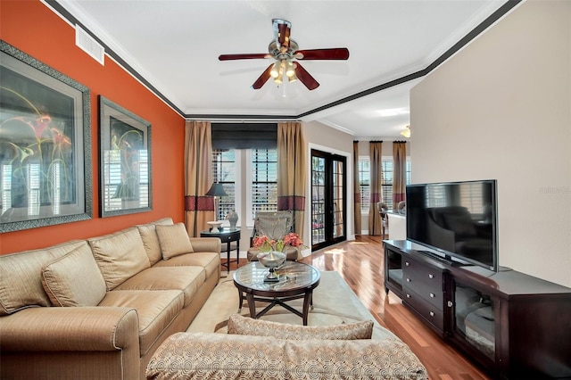 living room featuring ceiling fan, light wood-type flooring, french doors, and crown molding