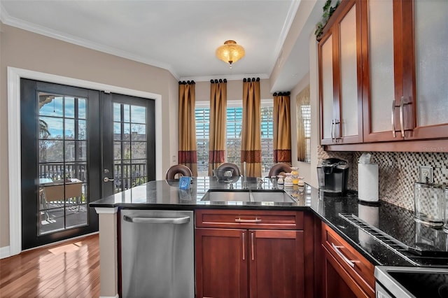 kitchen featuring sink, kitchen peninsula, stainless steel dishwasher, and ornamental molding