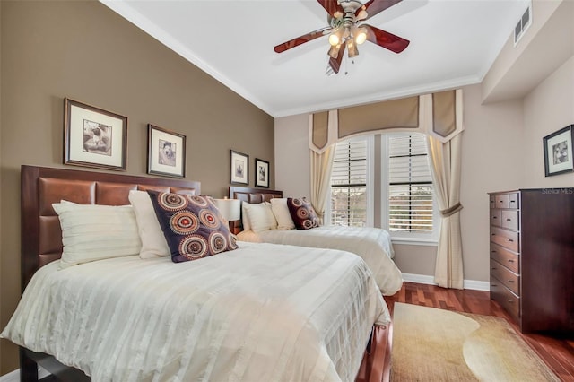 bedroom featuring ceiling fan, crown molding, and hardwood / wood-style floors