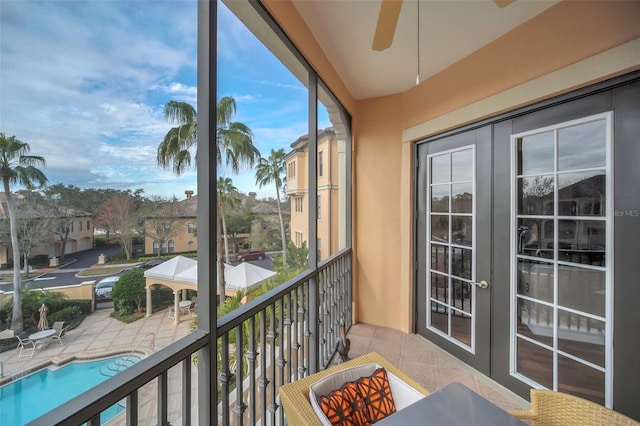 balcony featuring ceiling fan and french doors