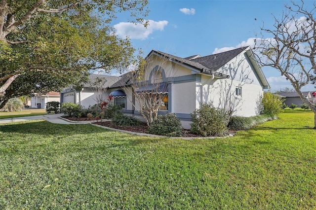 view of front of property with a front yard and a garage