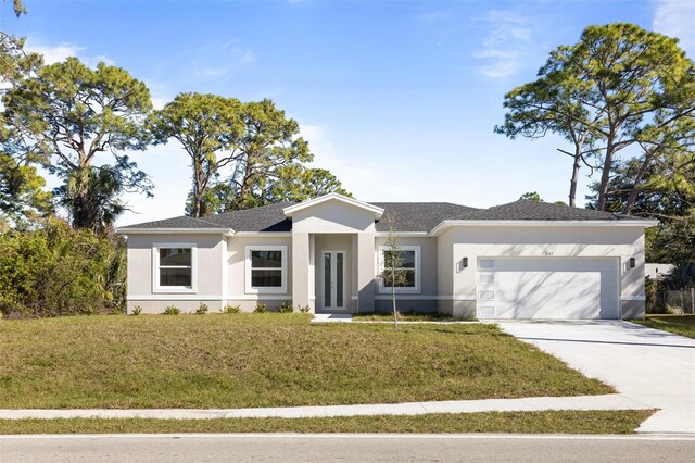 ranch-style house featuring a front lawn and a garage