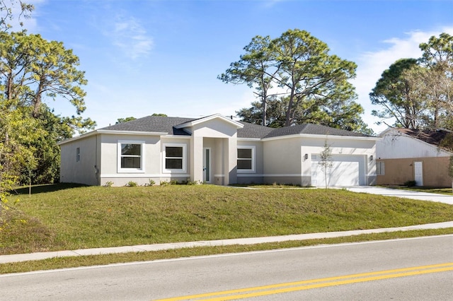 view of front of house featuring a front lawn and a garage