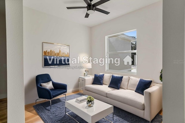 living room featuring light hardwood / wood-style floors and ceiling fan