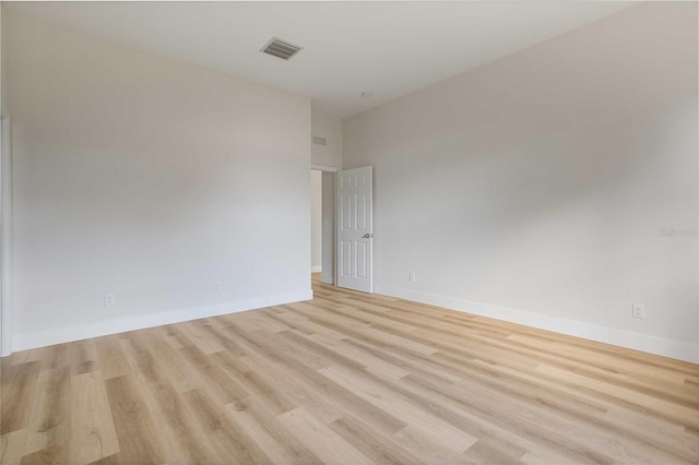 unfurnished room with light wood-type flooring