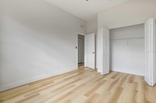 unfurnished bedroom with a closet and light hardwood / wood-style floors