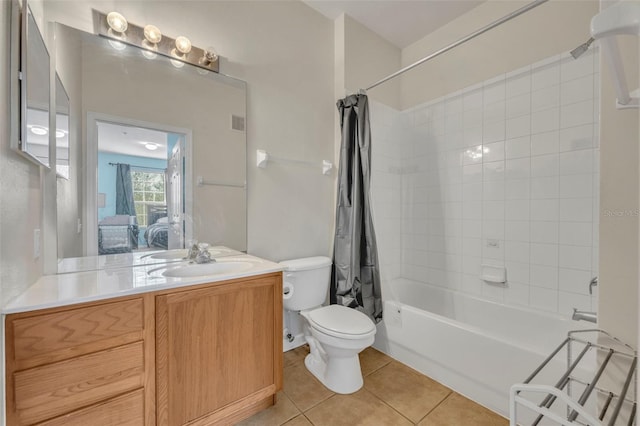 full bathroom featuring tile patterned floors, vanity, toilet, and shower / tub combo with curtain