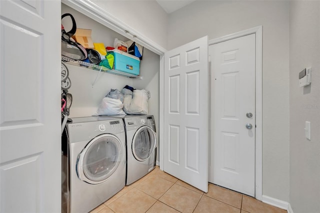 washroom with light tile patterned floors and separate washer and dryer