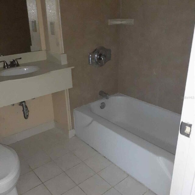 full bathroom featuring toilet, tile patterned flooring, sink, and shower / tub combination