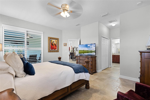 bedroom with ceiling fan and ensuite bath