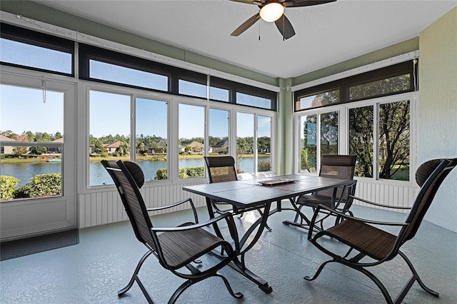 sunroom / solarium with a water view, a wealth of natural light, and ceiling fan