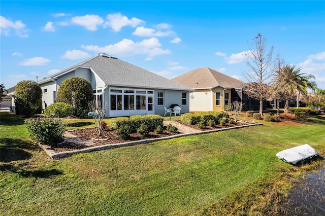 rear view of house featuring a yard