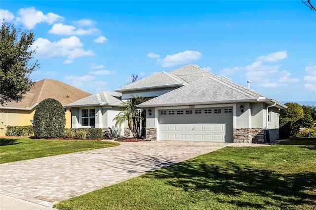 view of front facade with a garage and a front lawn