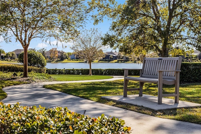 view of property's community featuring a water view and a yard