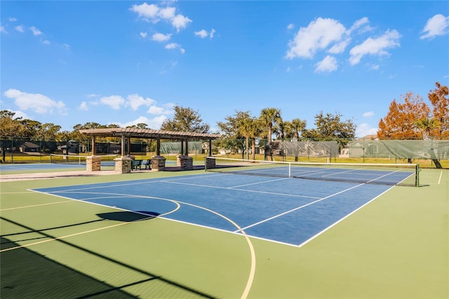 view of sport court with basketball court and a pergola