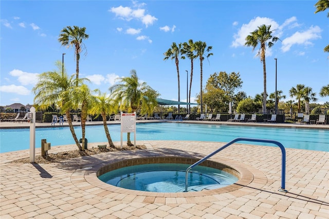 view of swimming pool with a community hot tub