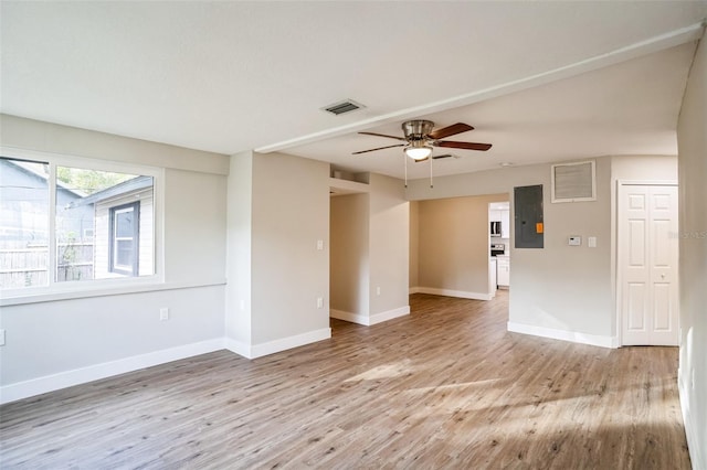 unfurnished room featuring electric panel, ceiling fan, and light hardwood / wood-style flooring