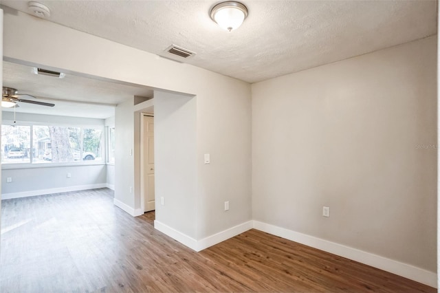 unfurnished room featuring a textured ceiling, ceiling fan, and hardwood / wood-style flooring