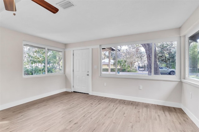 spare room featuring ceiling fan and light hardwood / wood-style flooring