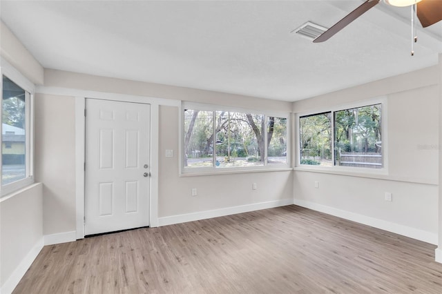 interior space with ceiling fan, a healthy amount of sunlight, and light wood-type flooring