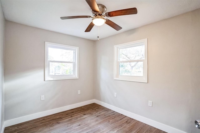 unfurnished room with wood-type flooring, ceiling fan, and a wealth of natural light