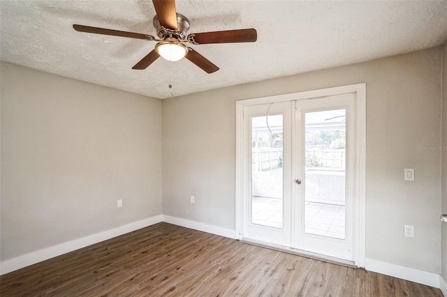 empty room with french doors, a textured ceiling, ceiling fan, and light hardwood / wood-style flooring