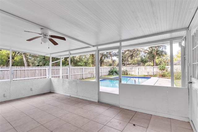 unfurnished sunroom featuring ceiling fan