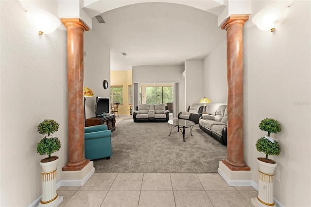 living room with light colored carpet and ornate columns