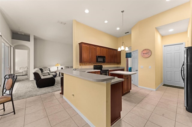 kitchen featuring light carpet, an inviting chandelier, kitchen peninsula, decorative light fixtures, and black appliances