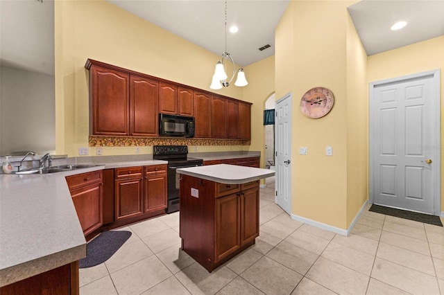 kitchen with decorative light fixtures, a kitchen island, black appliances, sink, and an inviting chandelier