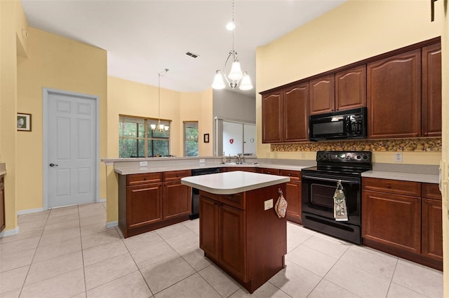 kitchen with kitchen peninsula, a notable chandelier, decorative light fixtures, a kitchen island, and black appliances